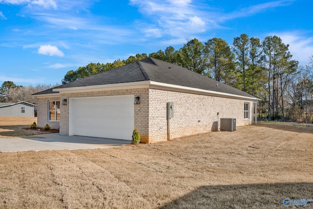 view of home's exterior with brick siding, central AC unit, driveway, and a garage