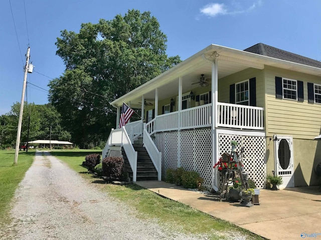 view of side of home featuring a porch and ceiling fan