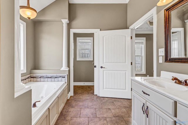 bathroom featuring vanity, a bath, and ornate columns