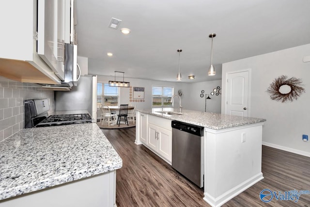 kitchen with a center island with sink, decorative light fixtures, sink, and appliances with stainless steel finishes