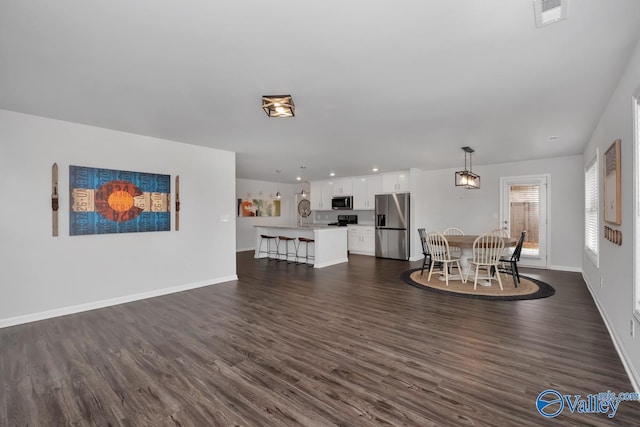 unfurnished living room featuring dark hardwood / wood-style floors