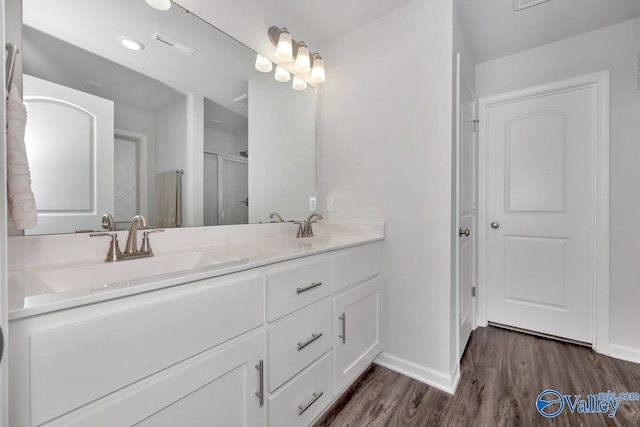 bathroom with hardwood / wood-style floors and vanity