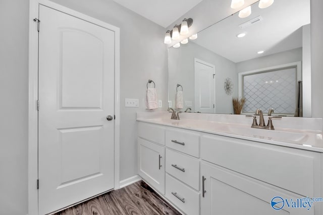 bathroom with vanity and hardwood / wood-style flooring