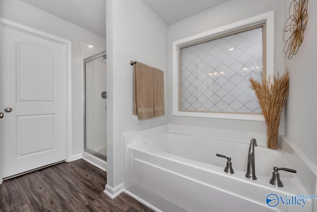 bathroom featuring hardwood / wood-style floors and independent shower and bath