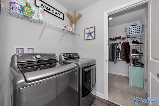 laundry room featuring washing machine and dryer and dark carpet