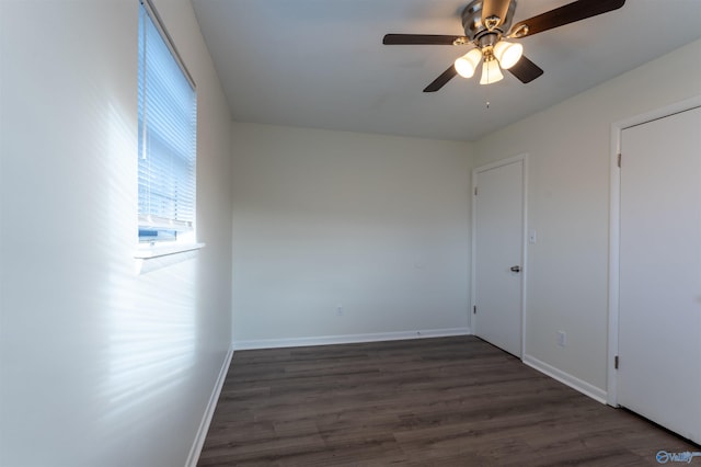 unfurnished room with dark wood-type flooring and ceiling fan