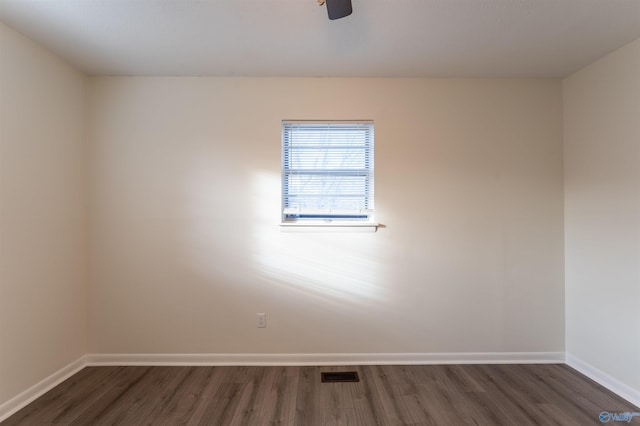 spare room with dark hardwood / wood-style floors