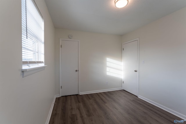 unfurnished room featuring dark hardwood / wood-style flooring