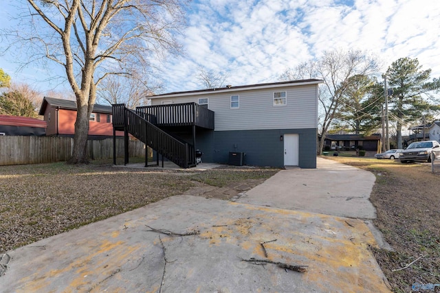 rear view of house featuring central air condition unit and a deck