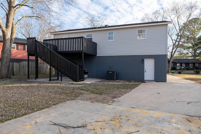 back of property with a wooden deck and central air condition unit