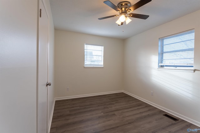 spare room featuring dark hardwood / wood-style floors and ceiling fan