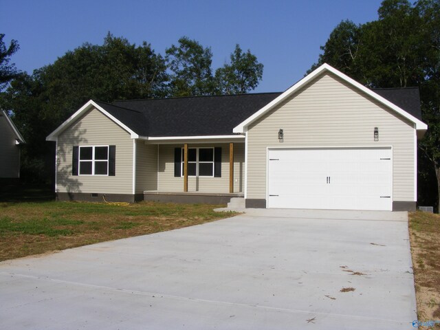 single story home featuring a garage and a front yard