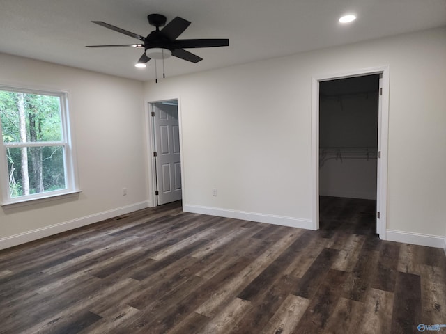 spare room featuring ceiling fan and dark hardwood / wood-style floors