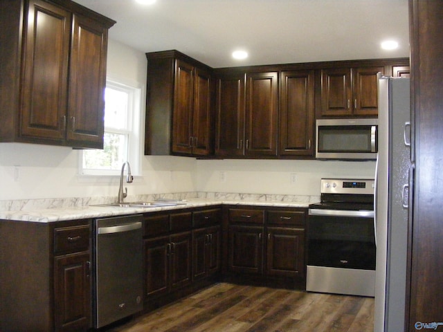 kitchen featuring appliances with stainless steel finishes, dark hardwood / wood-style floors, and dark brown cabinets