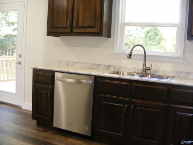 kitchen featuring dark wood-type flooring, dark brown cabinets, sink, and stainless steel dishwasher