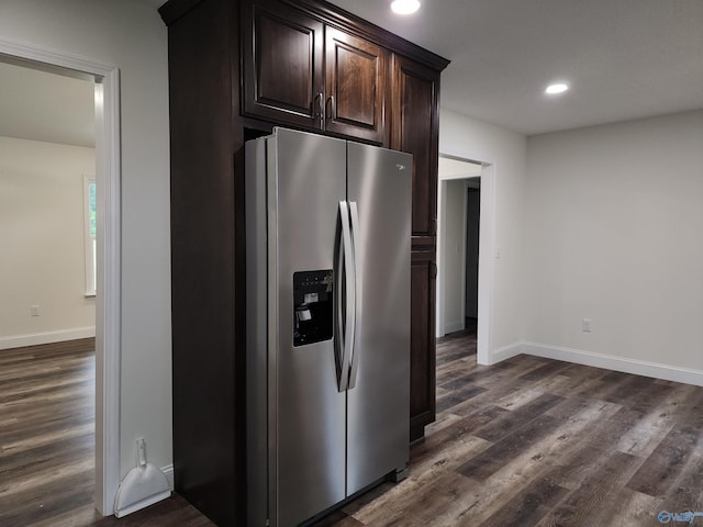 kitchen with dark brown cabinets, dark hardwood / wood-style flooring, and stainless steel refrigerator with ice dispenser