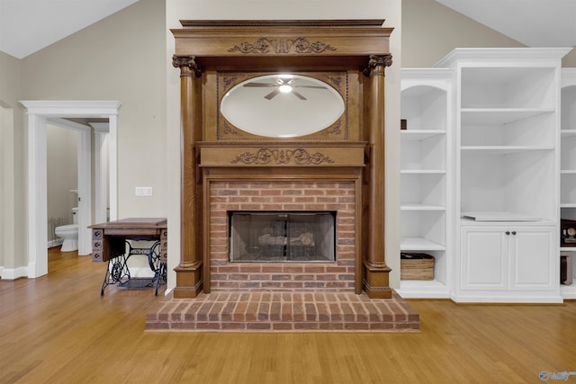 unfurnished living room featuring a fireplace, hardwood / wood-style flooring, vaulted ceiling, and ceiling fan