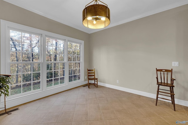 empty room with crown molding, light tile patterned floors, and a healthy amount of sunlight