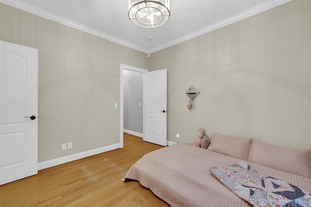 bedroom with ornamental molding, light hardwood / wood-style flooring, and a notable chandelier