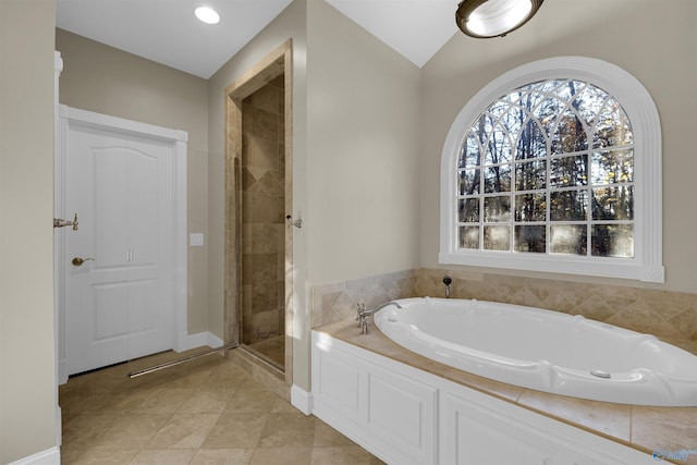 bathroom with tile patterned flooring, shower with separate bathtub, and vaulted ceiling