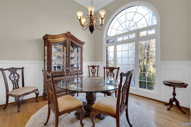 dining space featuring light hardwood / wood-style floors and an inviting chandelier