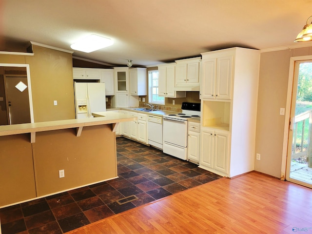 kitchen featuring white cabinets, a breakfast bar, dark hardwood / wood-style floors, and white appliances