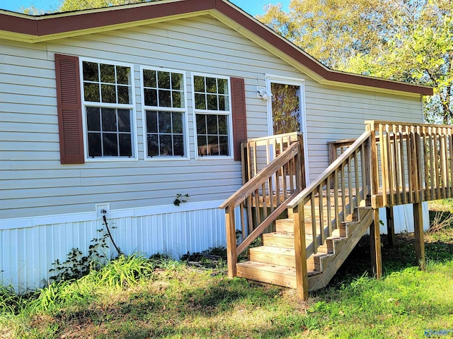 entrance to property featuring a wooden deck