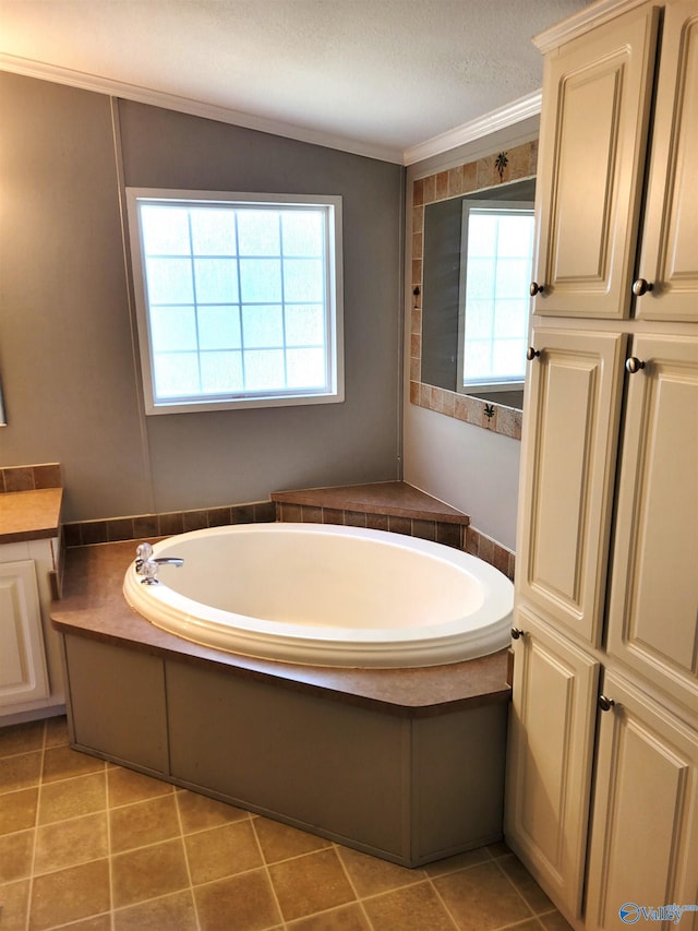 bathroom featuring plenty of natural light, a bathtub, a textured ceiling, and vanity