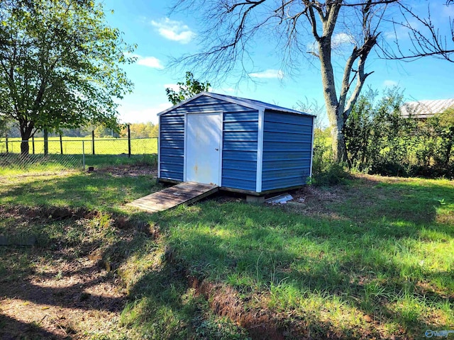 view of outdoor structure featuring a lawn