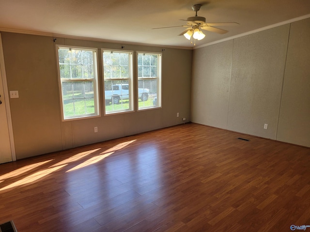 unfurnished room featuring hardwood / wood-style flooring, ceiling fan, and crown molding