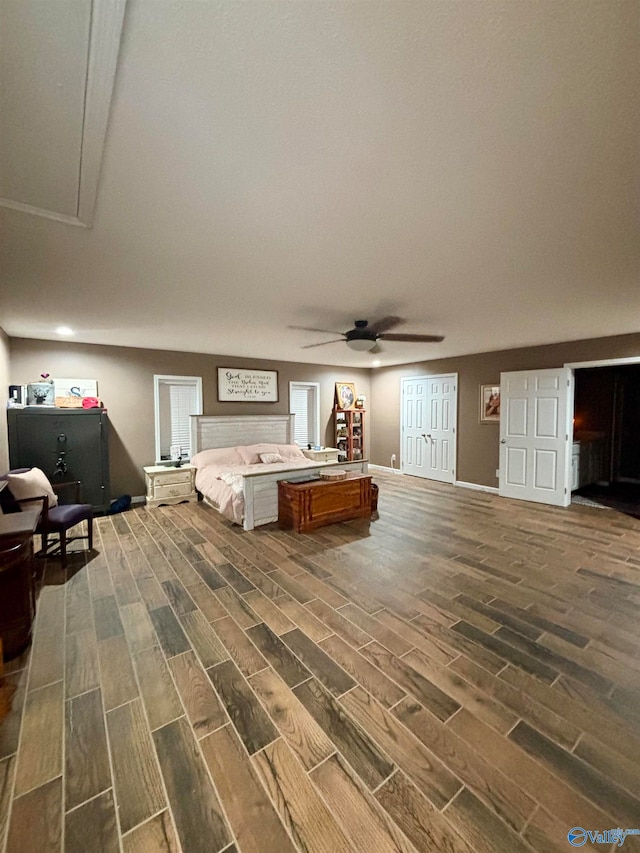 unfurnished bedroom with ceiling fan and dark hardwood / wood-style flooring