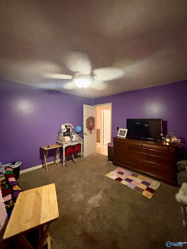 carpeted bedroom featuring a textured ceiling and ceiling fan