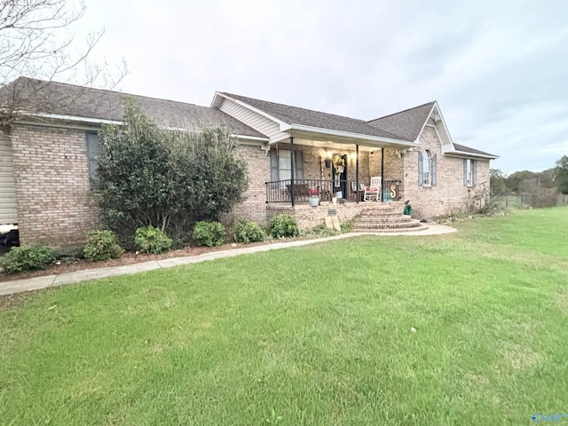 single story home with a front lawn and a porch