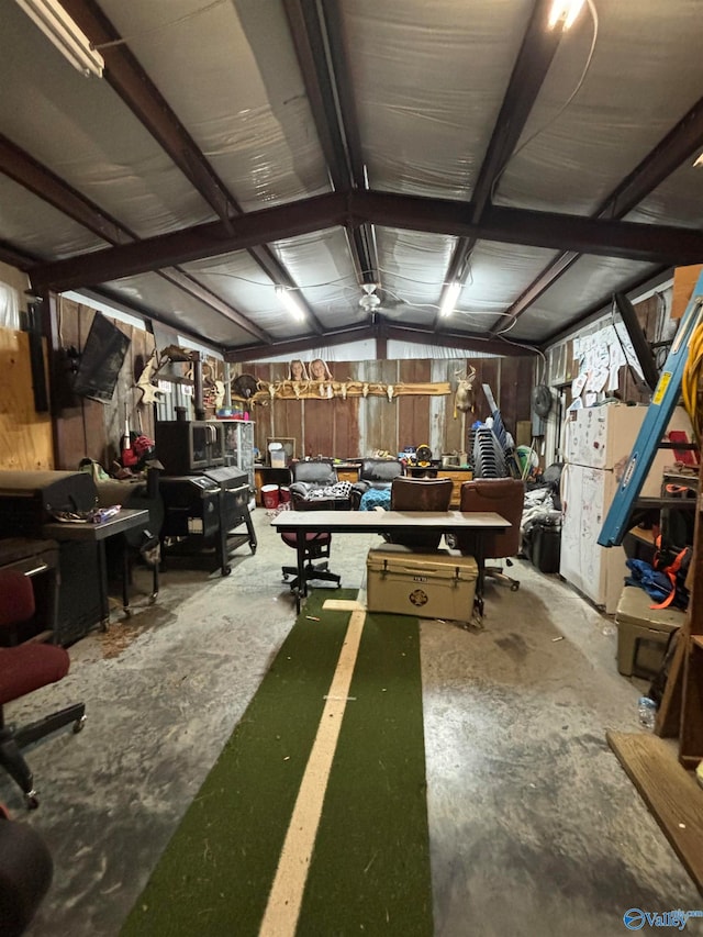 interior space with a workshop area, concrete floors, and lofted ceiling