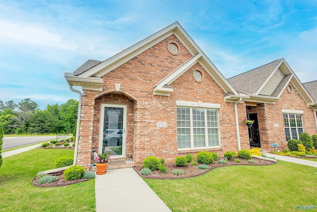 2522 Lindisfarne Dr SW, Decatur, AL 35603 - traditional home featuring brick siding, a front yard, and roof with shingles