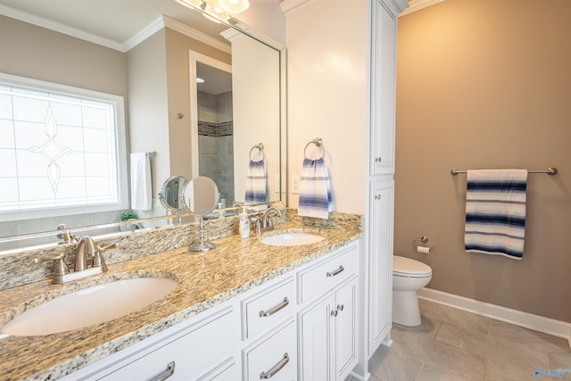 2522 Lindisfarne Dr SW, Decatur, AL 35603 - bathroom with baseboards, toilet, ornamental molding, double vanity, and a tile shower