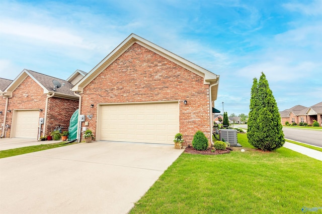 2522 Lindisfarne Dr SW, Decatur, AL 35603 - view of front of property with a front lawn, brick siding, concrete driveway, central air condition unit, and an attached garage