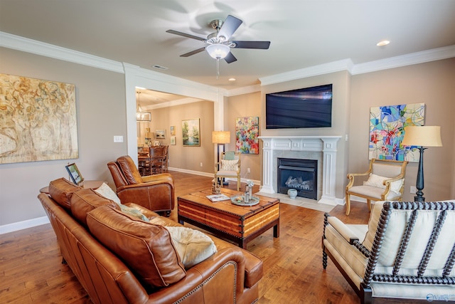 2522 Lindisfarne Dr SW, Decatur, AL 35603 - living room featuring ornamental molding, ceiling fan, wood finished floors, a fireplace with flush hearth, and baseboards