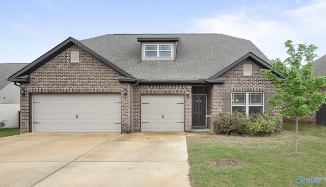 view of front of property with brick siding, a shingled roof, driveway, and a front yard