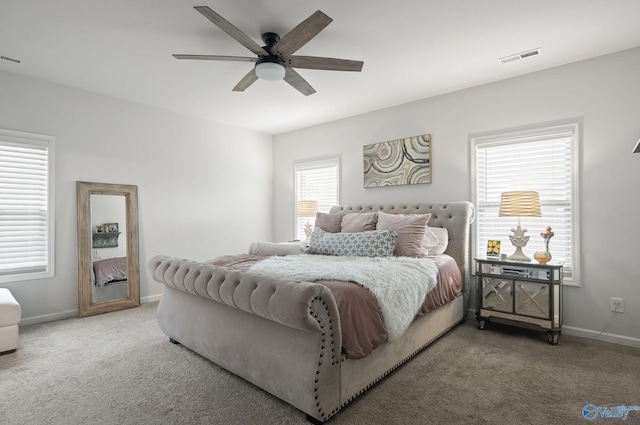 bedroom with visible vents, ceiling fan, carpet floors, and baseboards