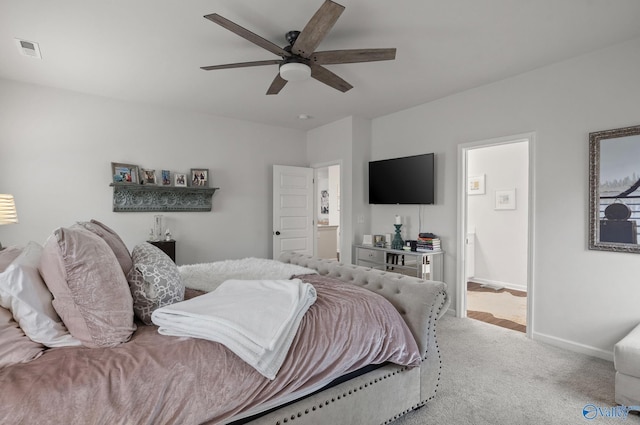 carpeted bedroom with visible vents, a ceiling fan, and baseboards