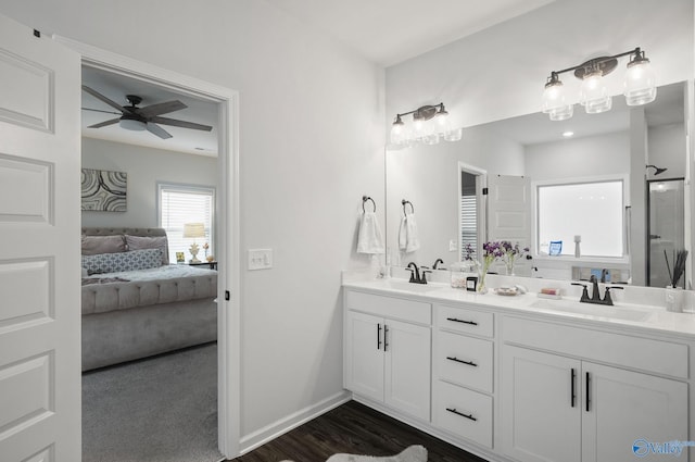 ensuite bathroom featuring double vanity, a sink, ceiling fan, and ensuite bathroom