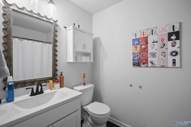 bathroom with toilet and vanity