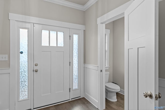 entrance foyer with dark hardwood / wood-style flooring and ornamental molding