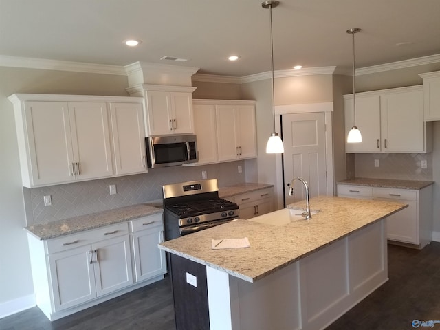 kitchen featuring sink, white cabinetry, an island with sink, and appliances with stainless steel finishes