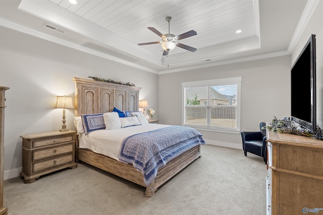 carpeted bedroom featuring wood ceiling, ceiling fan, ornamental molding, and a tray ceiling