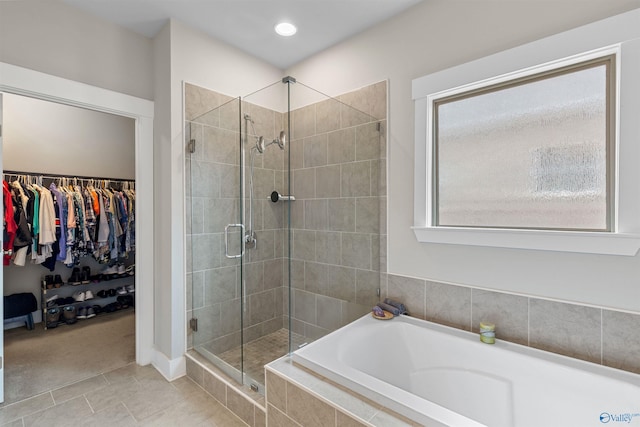 bathroom with separate shower and tub and tile patterned flooring