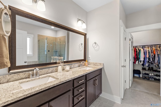 bathroom featuring tile patterned floors, vanity, and a shower with shower door