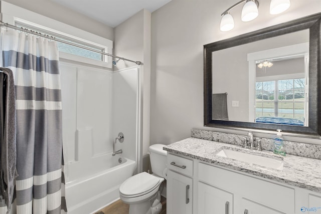 full bathroom with shower / tub combo with curtain, vanity, and toilet