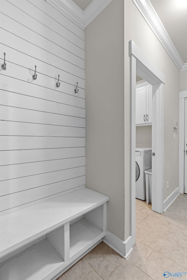 mudroom with crown molding and washer / dryer